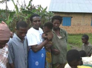 A Mothers' Union leader holds a malnourished baby among the Congolese refugees.